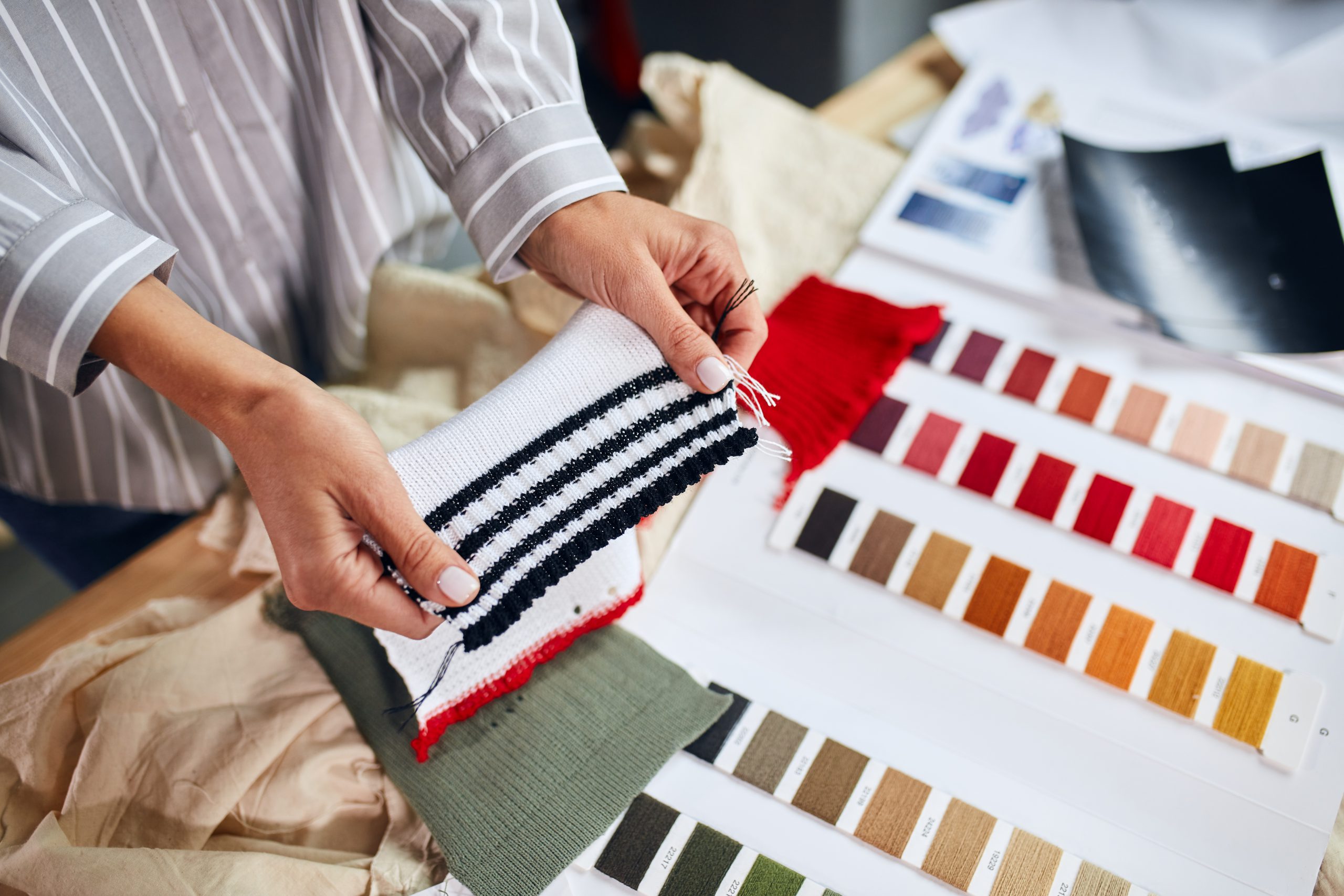 Woman Choosing A Fabric Color In A Store